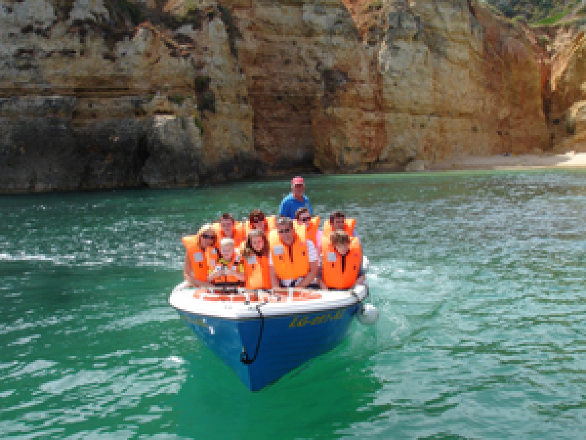 a group of people on a boat in the water